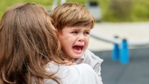 2-year-old experiencing a toddler meltdown and covering their face leaving their family to question - Why Does My 2-Year-Old Have Meltdowns