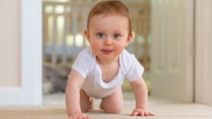 Baby making eye contact and reaching for toy, illustrating early social engagement and signs of autism at 12 months