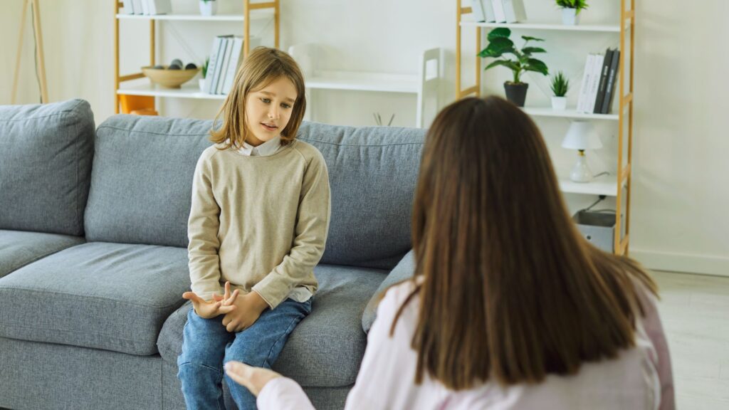 Child speaking with a therapist during an evaluation for “Does my child have autism, or is it just a speech delay?”