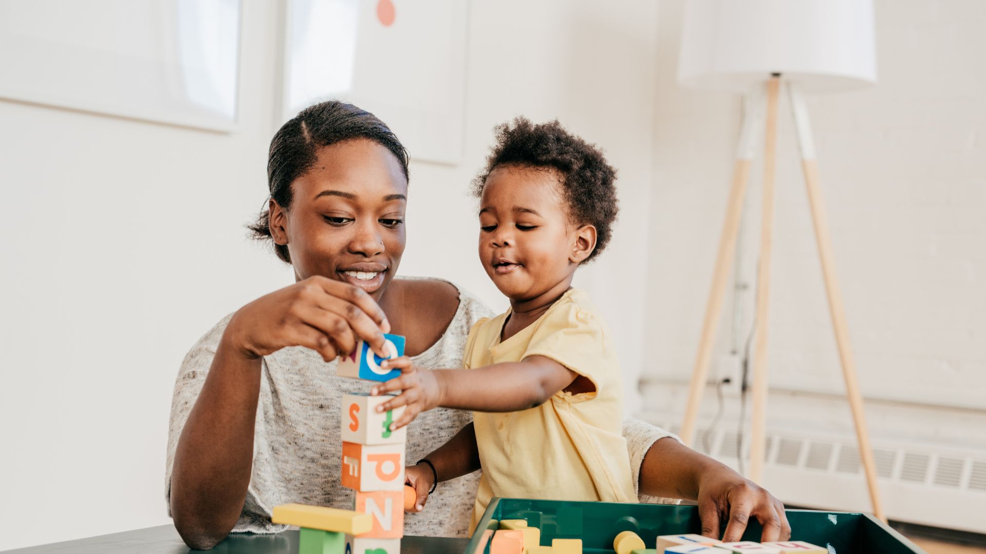 Mother uses early intervention aba therapy with toddler through play