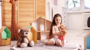 Young girl engaging with an autistic Barbie doll during quiet playtime