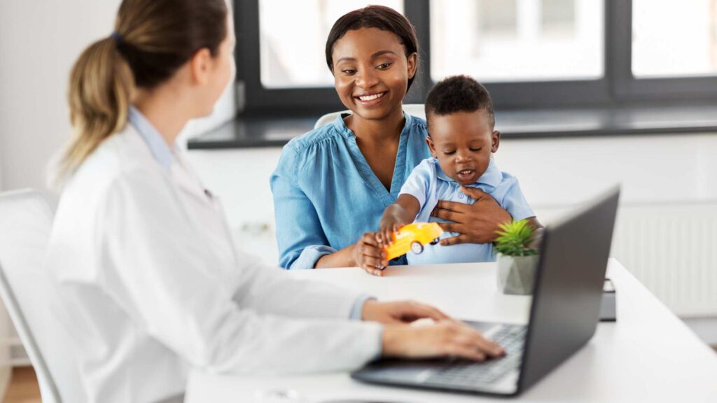 Parent and young child meeting with an ABA therapy provider in an office setting