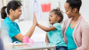 ABA therapist, parent, and child participating in a therapy session together