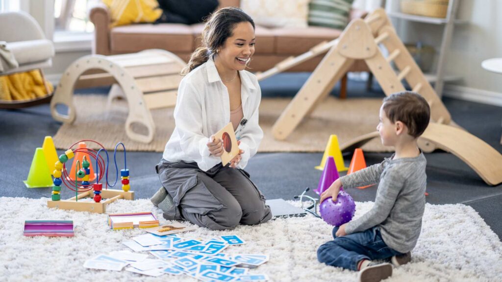 ABA therapist engaging a young child in a play-based early intervention session