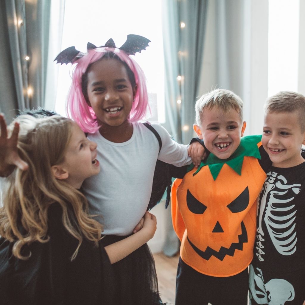 Children wearing Halloween costumes and celebrating together