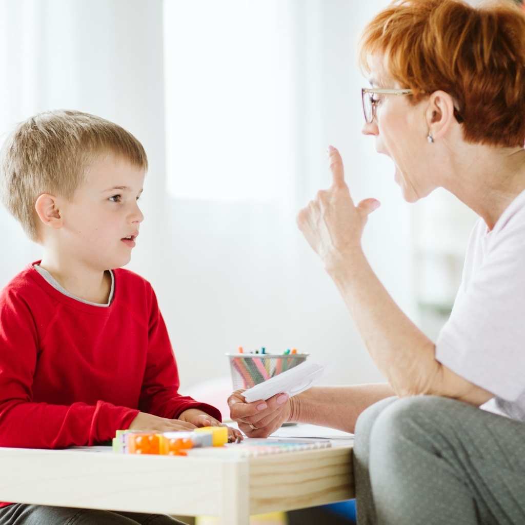 Adult guiding a young child through a hands‑on learning activity as part of ABA therapy after an autism diagnosis.
