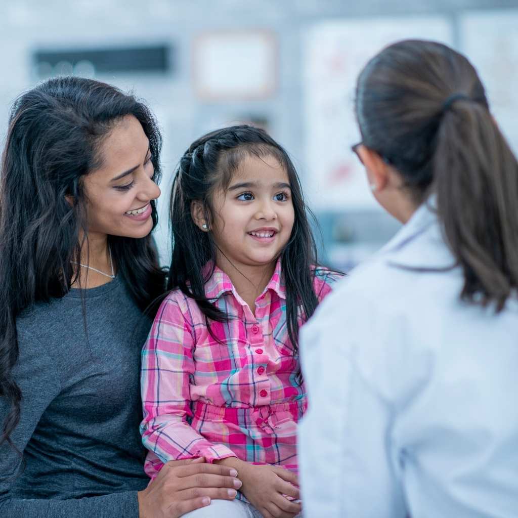 Child attending autism evaluation appointment with parent and specialist