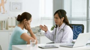 Healthcare professional speaking with a parent after a child's autism diagnosis