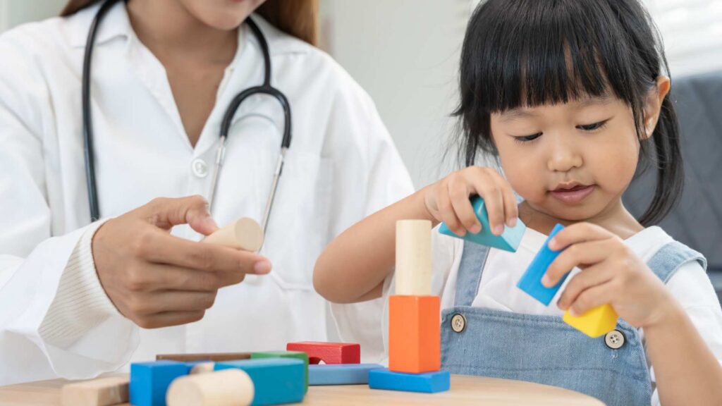 Child participating in autism evaluation for toddlers with specialist