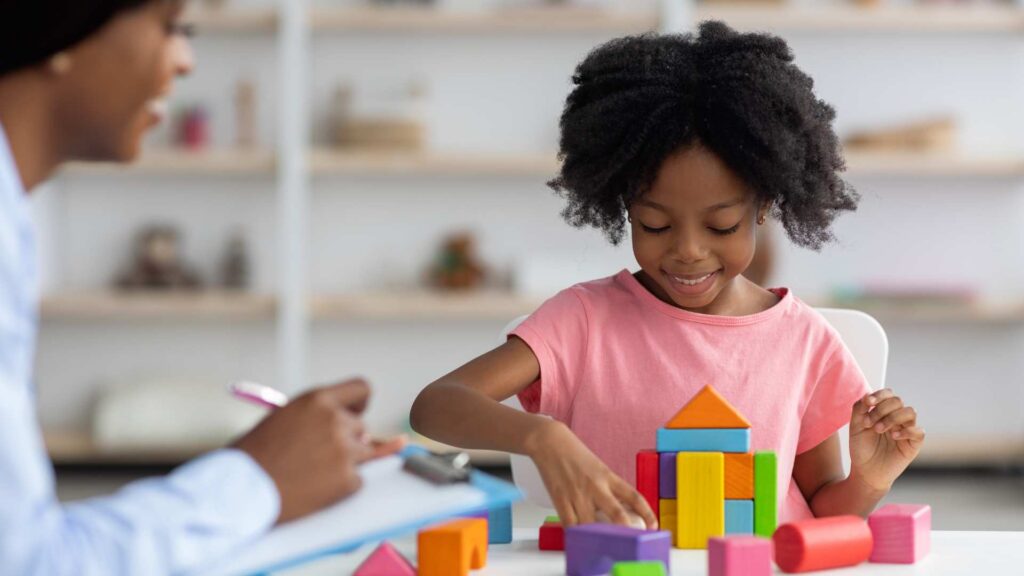 Child building with blocks during an evaluation for autism