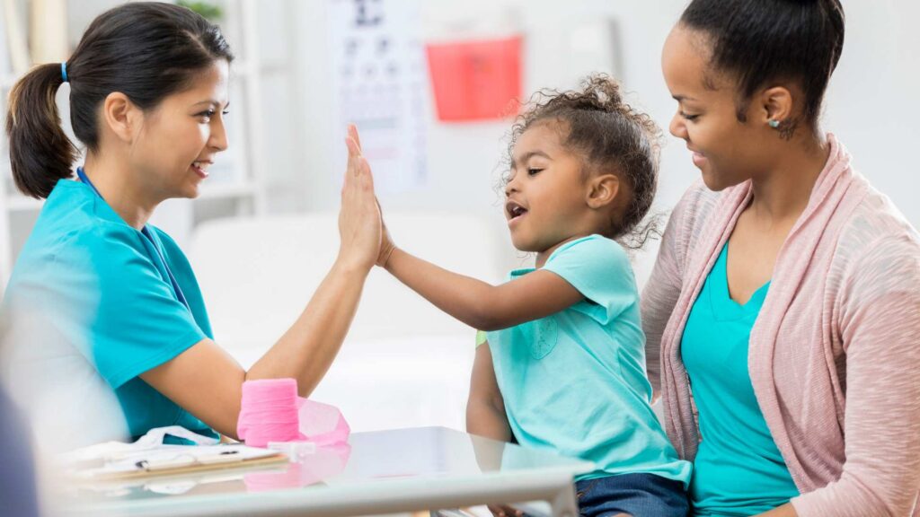 Child interacting with specialist during autism evaluation appointment