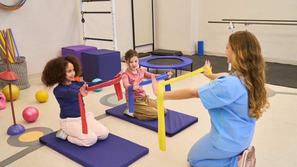 Children participating in developmental therapy during autism evaluation process