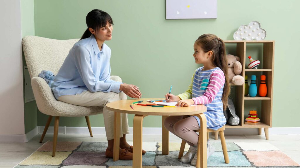 Clinician observing a child during the autism diagnosis process