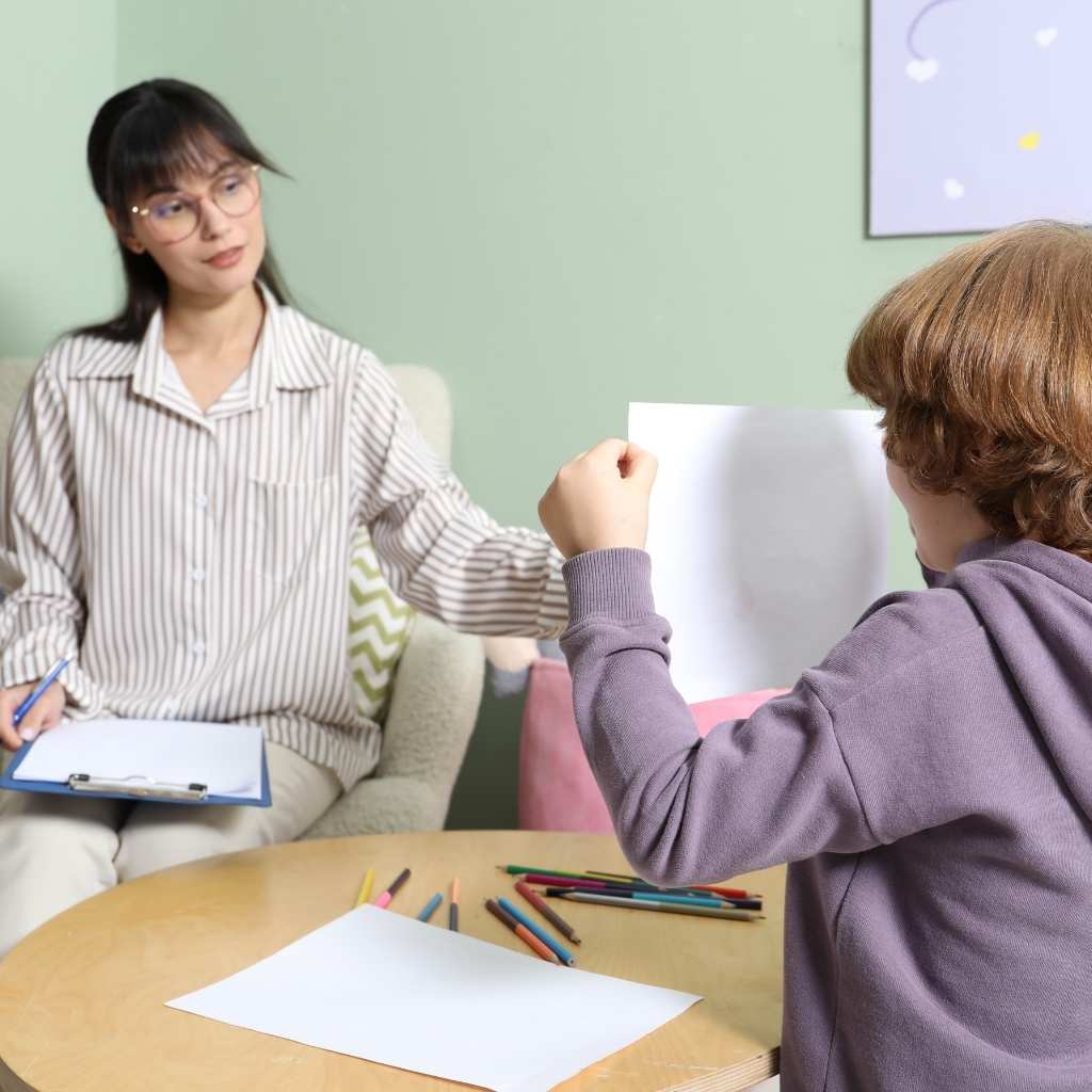 Doctor observing child during evaluation for autism in young children