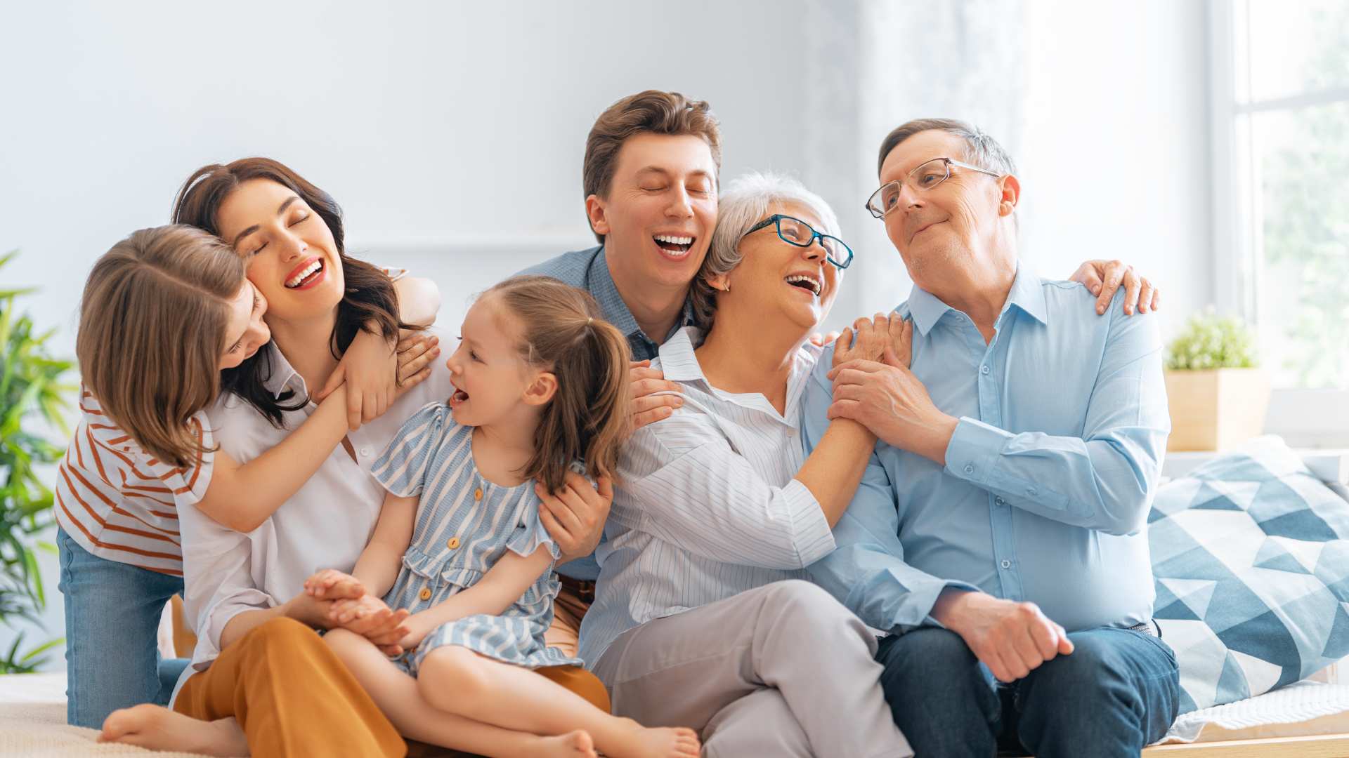 Three generations of a family sharing a joyful moment together after explaining autism to family