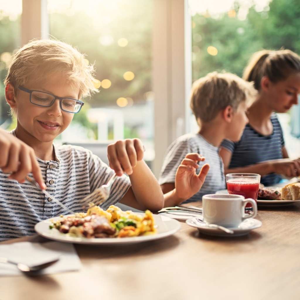 Family enjoying dinner together and sharing a consistent daily routine