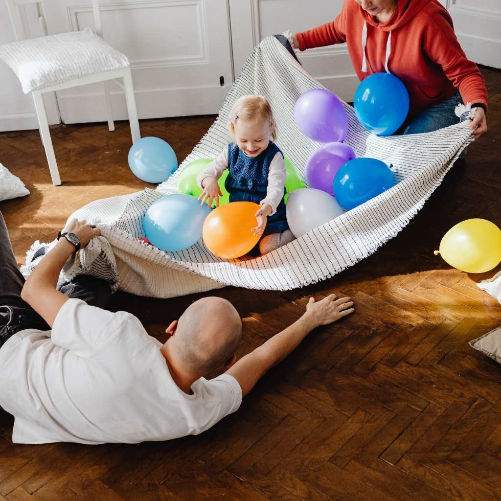 Adults playing with child after explaining autism to family