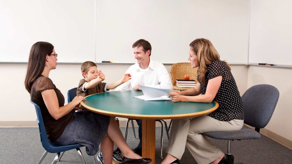 Parents and educators discussing individualized support for autism in school