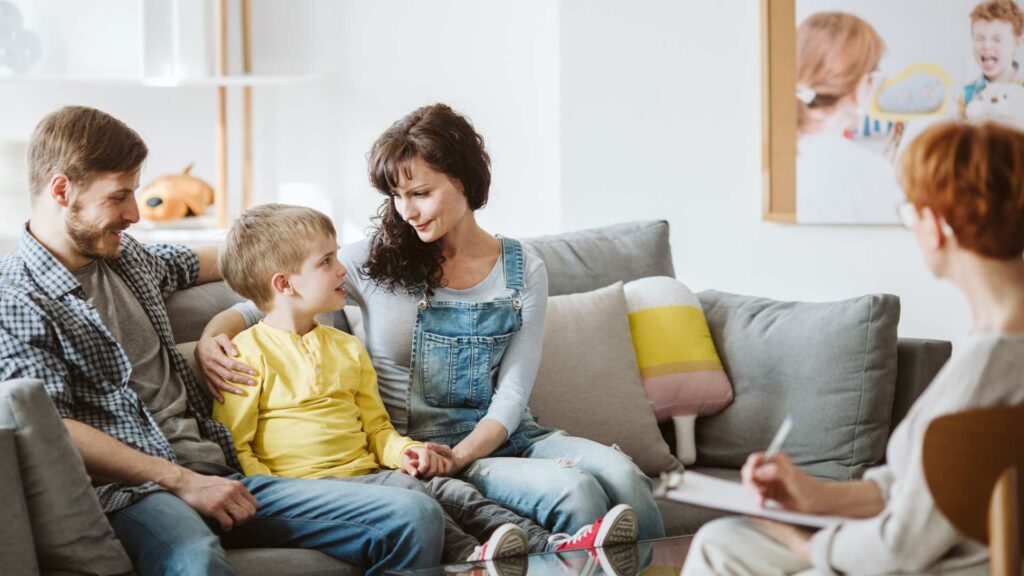 Parents and child meeting with a professional for guidance after an autism diagnosis