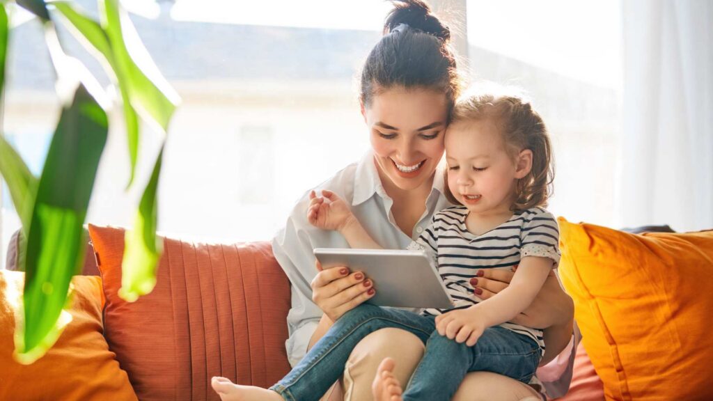 Mother and young child using a tablet together