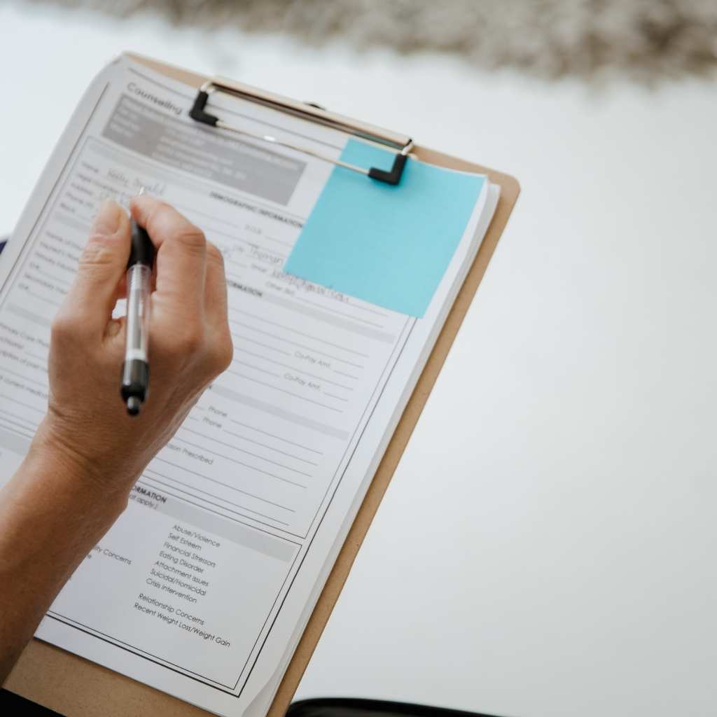 Healthcare professional filling out M-CHAT screening tool form