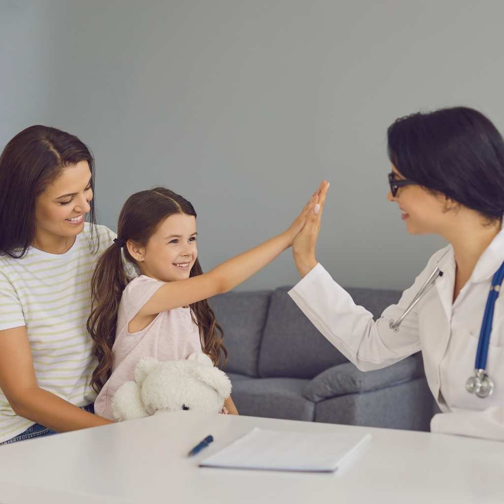 Child and parent celebrating a successful appointment with a healthcare professional after the child's autism diagnosis