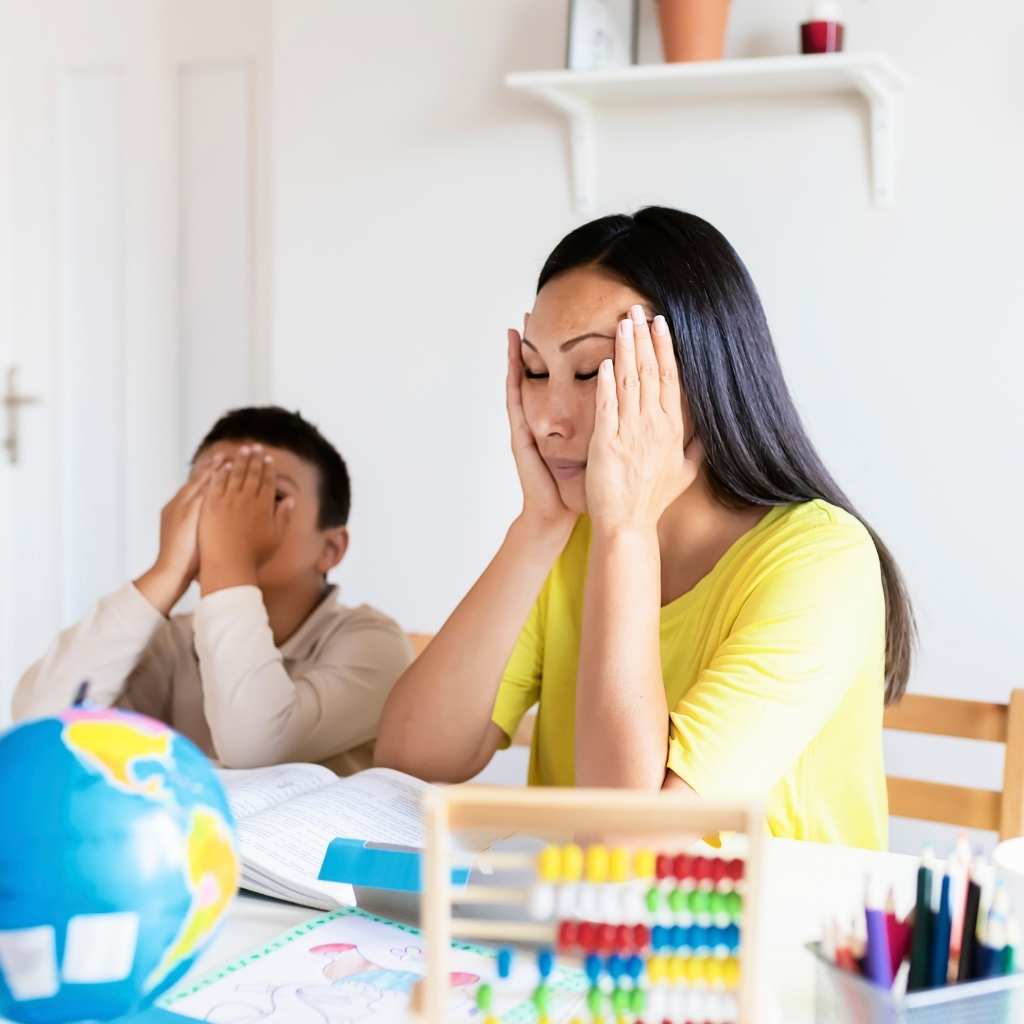Parent and child appearing overwhelmed during a learning activity at home