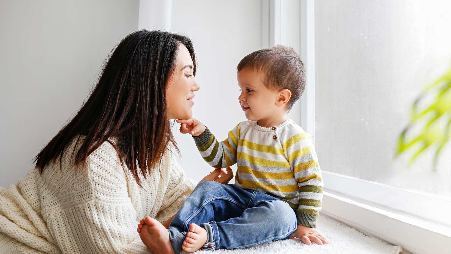 Parent and toddler engaging in face-to-face interaction to support ABA communication skills development
