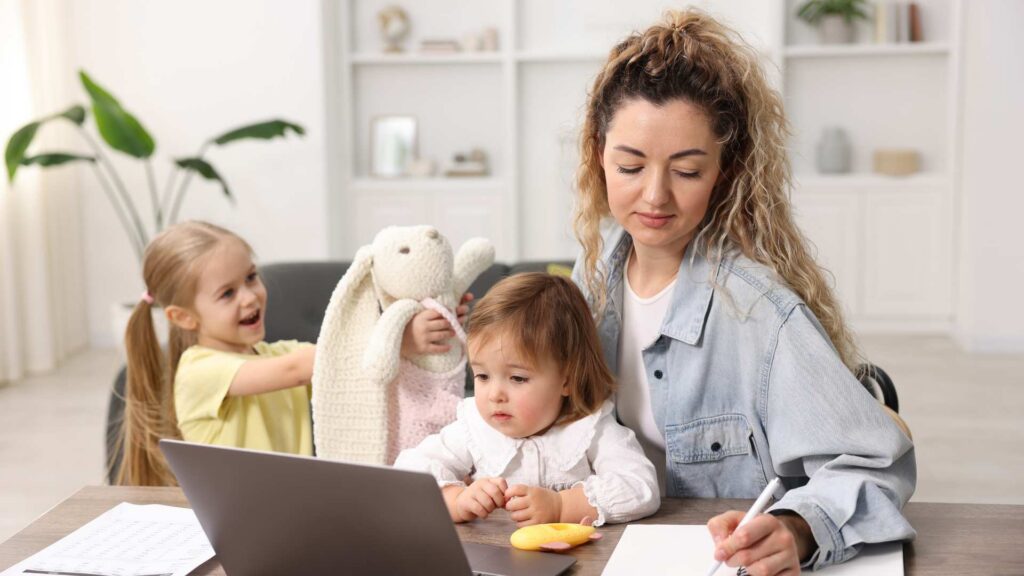Parent reviewing autism screening for toddlers information online with children nearby
