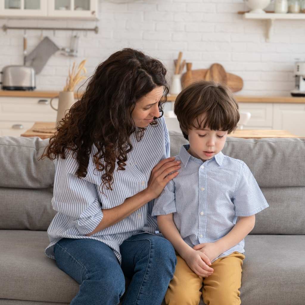 Parent comforting and encouraging a child during a calm moment at home