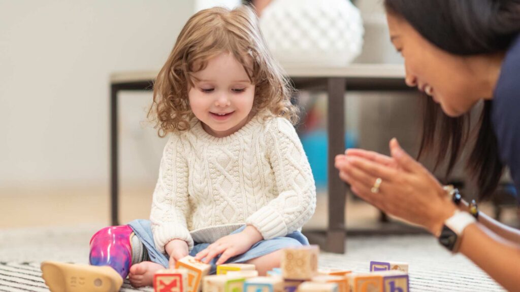 A child appears distracted or overwhelmed while sitting at a classroom desk. Early intervention services, including ABA therapy for toddlers, can help children develop skills that support attention, participation, and adaptation to daily routines.